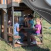 Backyard Discovery Canyon Creek Cedar Wood Swing Set with Wave Slide, Clubhouse, Play Kitchen, Picnic Area, Belt Swings, Web Swing, Rock Wall,...